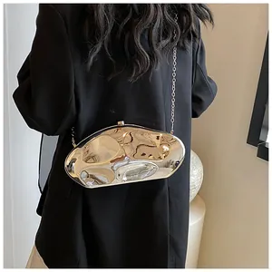 Close-up of a silver mirror acrylic evening bag with wavy liquid metal texture and chain