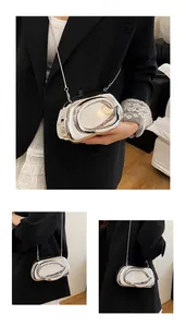 Macro detail of silver liquid metal texture evening bag with futuristic ring ornament