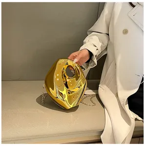 Detail of creative gold mirror acrylic evening box bag with molten liquid texture