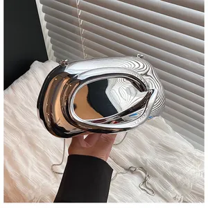 Close-up of silver mirror luxury evening clutch with irregular streamlined metal design