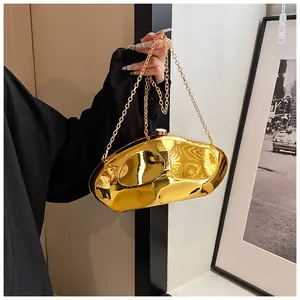 Detail shot of irregular gold mirror acrylic clutch bag with delicate metal chain strap
