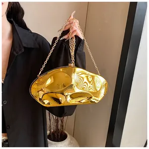 Detailed close-up of a glossy gold lava-style acrylic evening bag with a thin chain strap