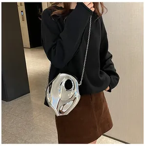 Detail shot of a silver metallic crossbody bag with irregular liquid fluid shape