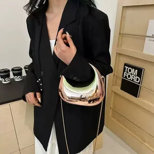 Chic rose gold crescent chain bag with a high-shine mirror finish and slim metal strap