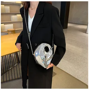 Detail of silver acrylic clutch with liquid metal texture and metallic chain strap