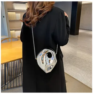 Silver metallic crossbody bag with geometric design shown on a female model