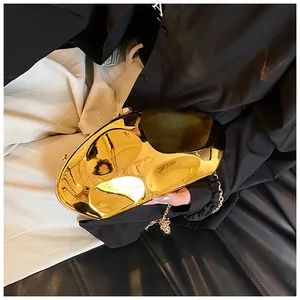 Detailed view of irregular gold acrylic evening clutch bag with reflective mirror finish