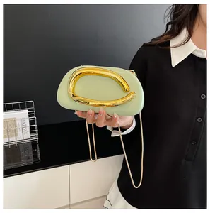 Detail van de lichtgroene PU-boxclutch met gouden hardware en kettingriem