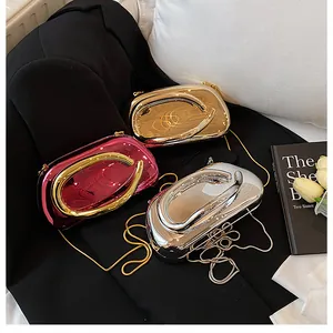 Three shiny metallic evening clutch bags in pink, gold, and silver with chain straps