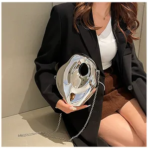 Silver liquid metal crossbody bag with mirror finish and slim chain strap shown on model