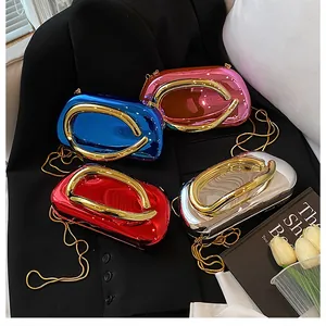 Detailed view of four colorful glossy evening bags with golden U-shaped metal handles
