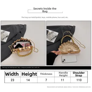 Size chart and interior capacity view of a gold shell acrylic evening clutch bag