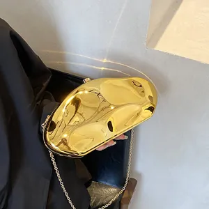 Polished gold pebble acrylic clutch bag with delicate metal chain for evening events