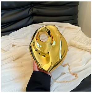 Detailed view of the gold irregular lava-effect acrylic box clutch with mirror finish