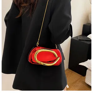 Red metallic evening clutch bag with large gold ring handle and chain strap for women