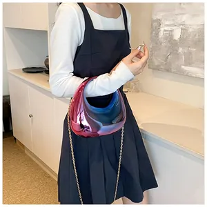 Détail de la pochette en acrylique translucide avec dégradé, chaîne dorée et fini métallique