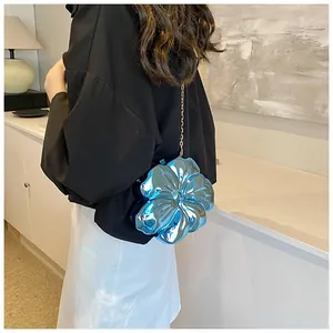 Dettaglio di una borsa a tracolla blu metallizzato a forma di fiore 3D con catena oro