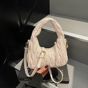 Quilted minimalist underarm bag in beige with diamond patterns and gold chain