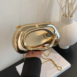 Luxury gold pebble clutch evening bag with circular hollow handle and snake chain strap