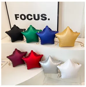Detail of star-shaped crossbody bags in eight metallic colors with gold chain straps