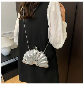 Silver shell-shaped acrylic evening bag with metallic texture and ball clasp on model back
