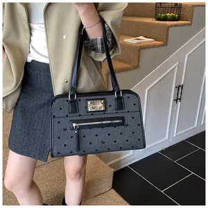 Gros plan sur la texture à pois avec petits nœuds et plaque de logo en métal sur le sac à main