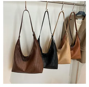 Close-up of woven texture and adjustable strap on large capacity vegan leather tote bag