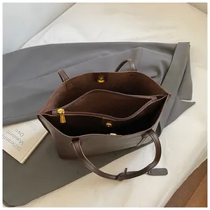 Top view of the brown tote bag interior featuring dual compartments and a zipper divider