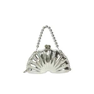 Shell shaped silver acrylic evening clutch bag with beaded handle and chain strap