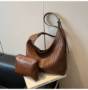 Detail of dark brown woven leather hobo bag with matching inner pouch and adjustable strap