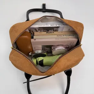 Top view of large capacity crossbody bag interior showing books, umbrella and cosmetics