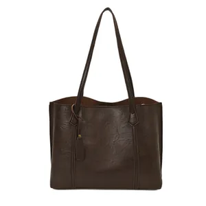 Minimalist deep brown leather tote bag with vintage texture and slender shoulder straps