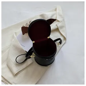 Top view of black leather bucket bag showing burgundy lining and golden hardware