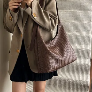 Detailed view of dark brown woven leather tote bag texture and large capacity fit