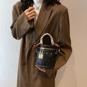 Chic black cylinder bucket bag with gold locks and leopard print scarf handle wrap
