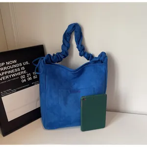 Detail of blue frosted tote bag with unique cloud-pleated handle for daily commute