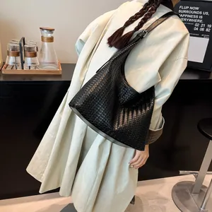 Detail of black woven leather hobo bag showing large capacity and soft texture