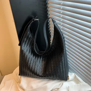Detail of black woven leather hobo bag showing intricate texture and large capacity