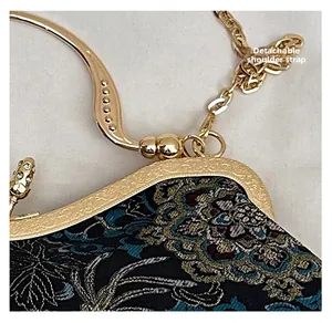 Detail of evening clutch with floral embroidery and detachable gold chain strap