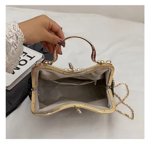 Detail view showing the spacious grey fabric interior and zipper pocket of shell handbag