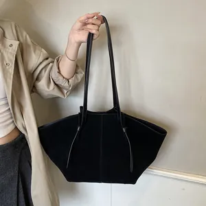 Minimalist black oversized wing tote bag in matte suede with stylish knotted straps
