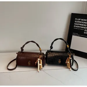 Detail showing retro wrinkled texture and woven handles of brown and black leather bags