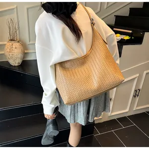 Retro woven hobo tote bag in beige leather shown on model for a chic daily commute