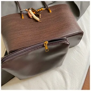 Detail of coffee woven tote bag with inner pouch and stylish wooden bead decoration