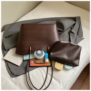 Detailed view of large brown woven tote bag interior showing inner pouch and storage capacity
