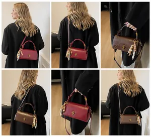Detailed view of vintage glossy leather shoulder bags in burgundy and dark brown