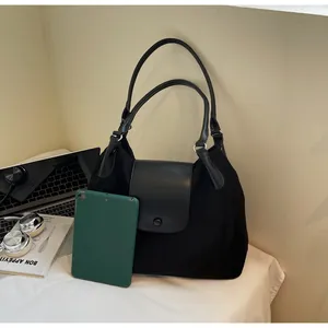 Spacious black matte faux leather tote bag showing capacity for tablets and office essentials