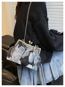 Détail d'un sac à main jacquard vintage avec cadre doré et fermoir en perle