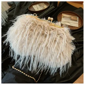 Close-up of beige feather clutch bag with gold clasp and elegant bead chain strap