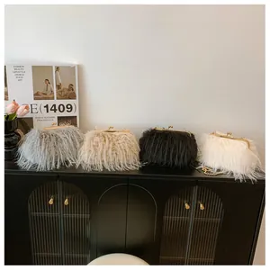 Detail of luxury faux fur evening bags with gold clasp and chain in four elegant colors
